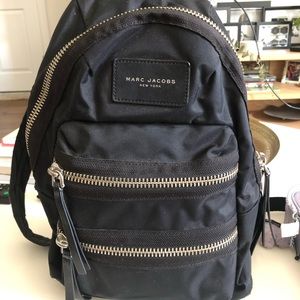 Marc Jacob black bag pack with silver zipper detail.